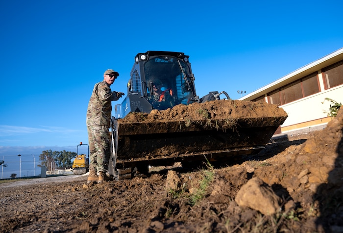 Master Sgt. Matthew Smith, 446th Civil Engineer Squadron pavement and construction equipment NCOIC, provides guidance for moving dirt to an Airman at Moron Air Base, Spain, on May 6, 2025.