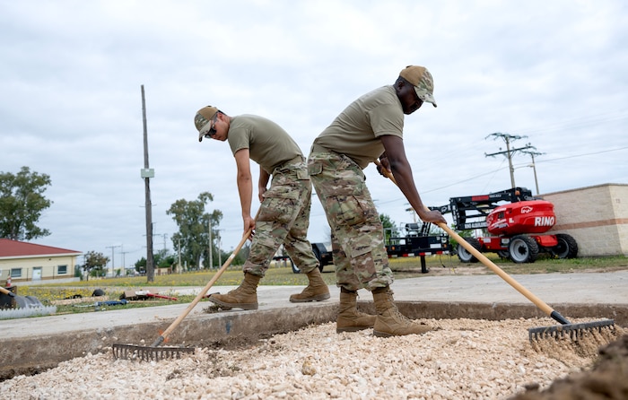 Senior Airmen Kyu Wintersteen and James Kamau, 446th Civil Engineering Squadron pavement and construction equipment, level gravel to prep the area for a concrete pour on May 9, 2025, at Moron Air Base, Spain.