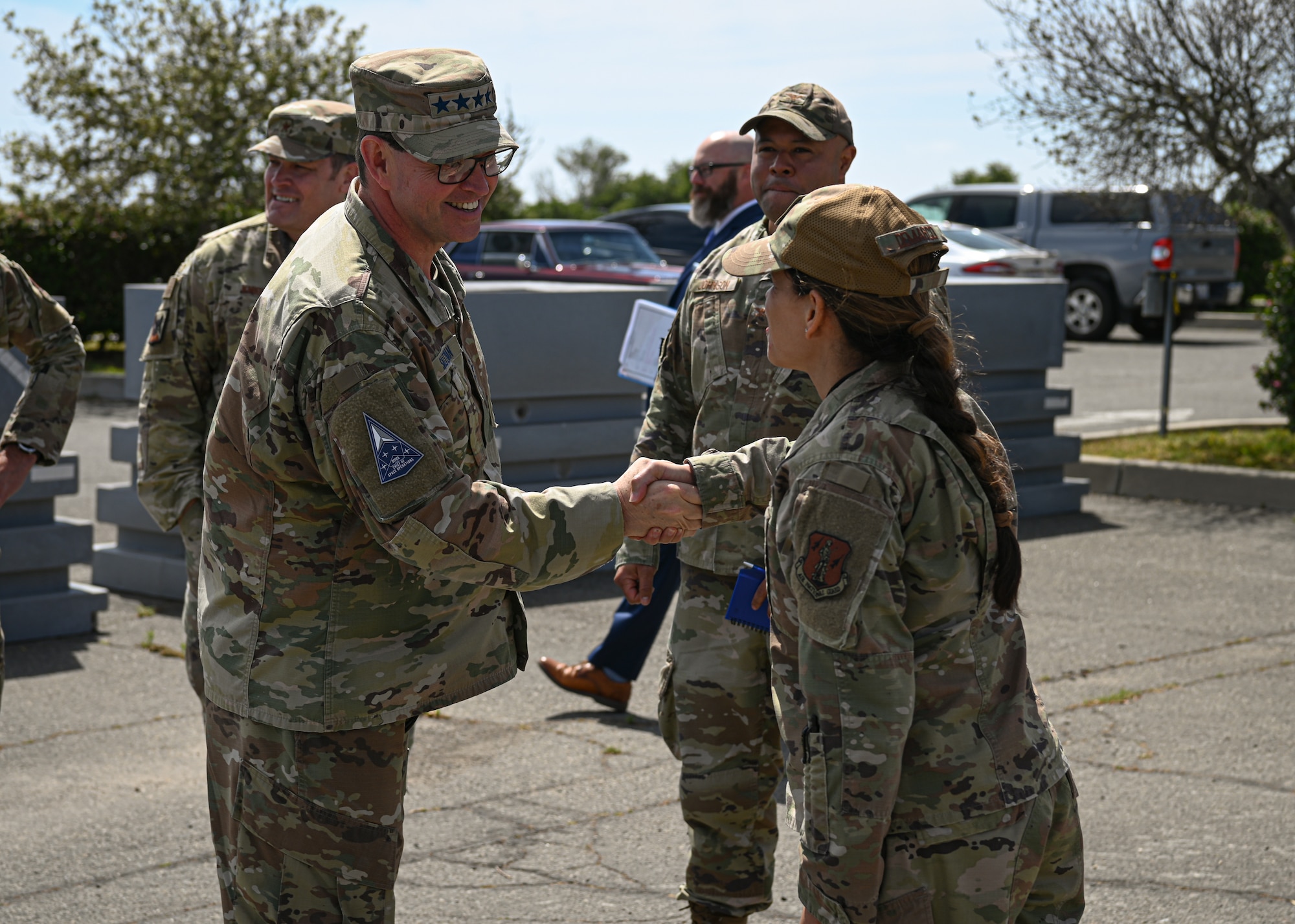 U.S. Space Force Chief of Space Operations Gen. Chance Saltzman shakes hands with Lt. Col. Sahira DeMarco, 148th Space Operations Squadron commander, in front of the 148th SOPS building located at Vandenberg Space Force Base.
