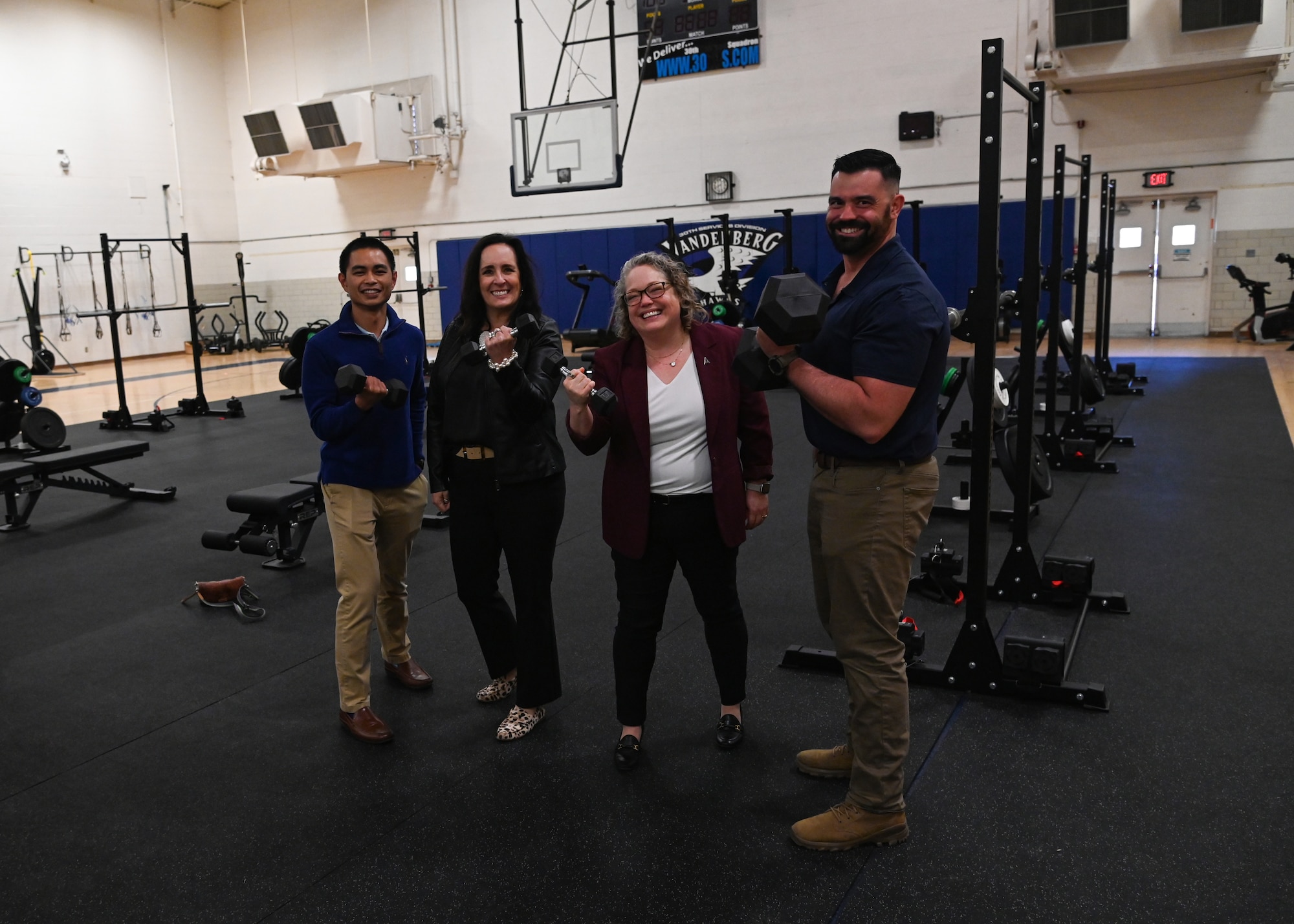 ennifer Saltzman, spouse of Gen. Chance Saltzman, U.S. Space Force Chief of Space Operations, and Mary Shoemaker, spouse of Col. Mark Shoemaker, Space Launch Delta 30 commander, train with Human Performance Optimization Center (HPOC) personnel and pose for a photo at Vandenberg Space Force Base.
