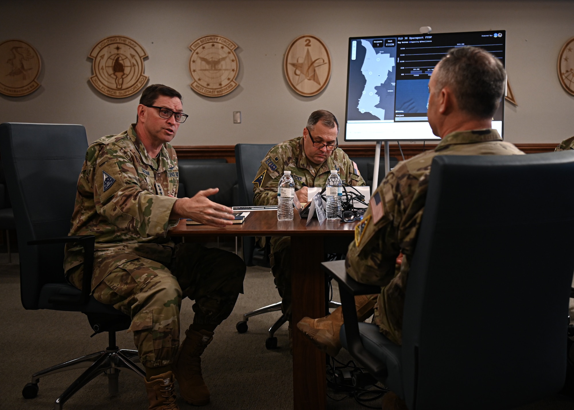 U.S. Space Force Chief of Space Operations Gen. Chance Saltzman, left, discusses key mission objectives with U.S. Space Force Col. Mark Shoemaker, Space Launch Delta 30 commander, right, and Col. Dorian Hatcher, Space Launch Delta 30 deputy commander, center, during a meeting in the Delta headquarters conference room at Vandenberg Space Force Base.