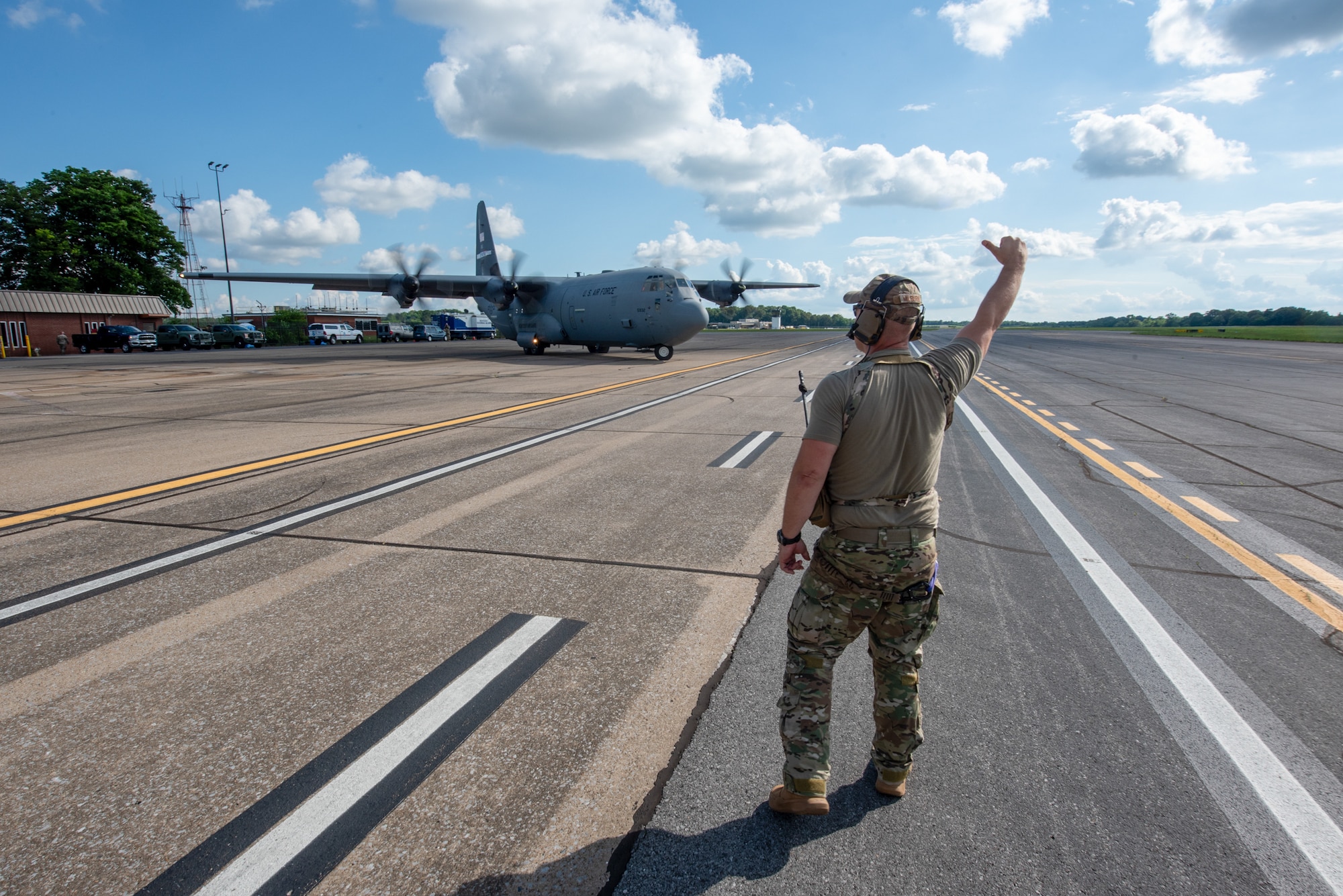 Master Sgt. Brian Milburn, a loadmaster with the 123rd Contingency Response Group, directs a Kentucky Air National Guard C-130J Super Hercules at Barkley Regional Airport in Paducah, Ky., May 13, 2025, during Exercise Grindstone, a major earthquake-response simulation. Paducah lies within the New Madrid Seismic Zone, the most active seismic area in the Eastern United States. (U.S. Air National Guard photo by Phil Speck)
