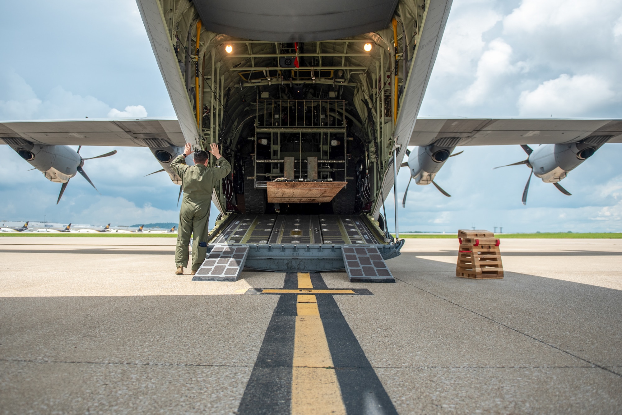 A loadmaster with the 123rd Contingency Response Group directs the loading of an all-terrain forklift onto a C-130J Super Hercules at the Kentucky Air National Guard Base in Louisville, Ky., May 13, 2025, in support of Exercise Grindstone, a major earthquake-response simulation. The forklift was being airlifted to Barkley Regional Airport in Paducah, Ky., where the unit’s Airmen were tasked with standing up an aerial port to function as a cargo hub and evacuation center as part of the earthquake scenario. (U.S. Air National Guard photo by Senior Airman Annaliese Billings)