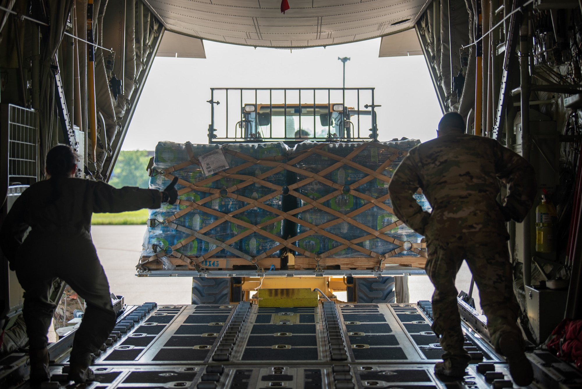 Loadmasters from the 165th Airlift Squadron load a pallet of water onto a C-130J Super Hercules at the Kentucky Air National Guard base in Louisville, Ky., May 14, 2025, in support of Exercise Grindstone, a major earthquake-response simulation. The water was being airlifted to Paducah, Ky., for humanitarian relief efforts as part of the earthquake scenario. (U.S. Air National Guard photo by Phil Speck)
