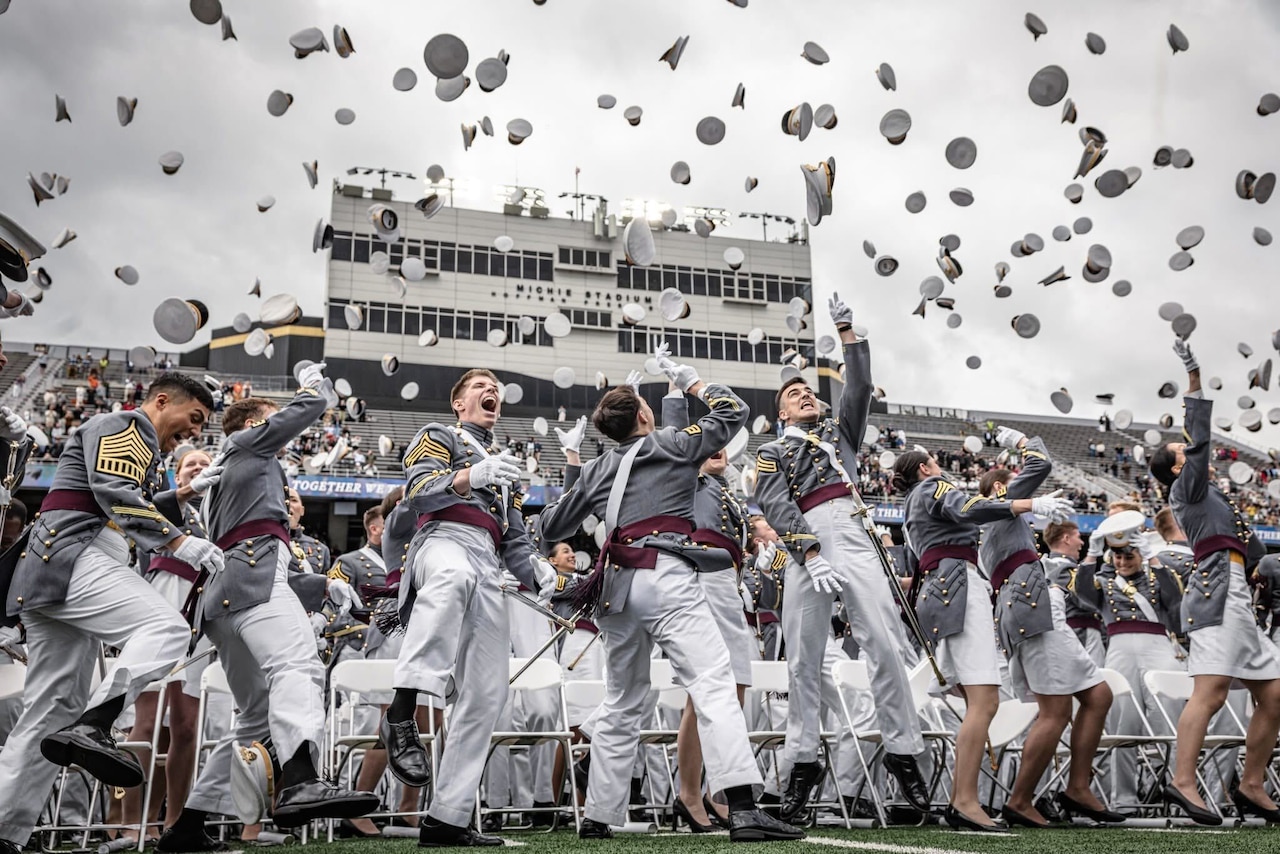 U.S. Military Academy cadets throw their caps during a graduation ceremony.
