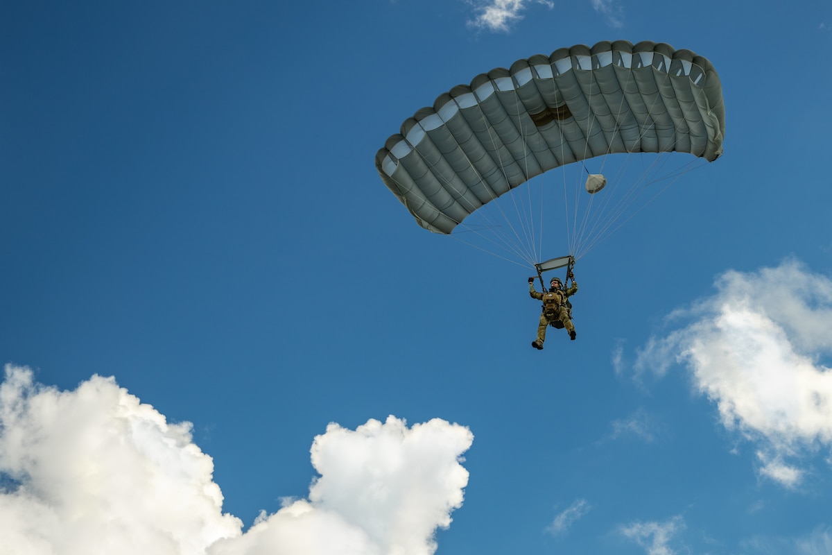 A combat controller from the Kentucky Air National Guard’s 123rd Special Tactics Squadron parachutes into Barkley Regional Airport in Paducah, Ky., May 13, 2025, from a C-130J Super Hercules aircraft in support of Exercise Grindstone, a three-day earthquake-response scenario staged in the New Madrid Seismic Zone, the most active seismic area in the Eastern United States. The Airmen conducted an assessment of airfield operability and provided air traffic control for follow-on aircraft bringing troops, cargo and equipment needed to establish an aerial port for relief operations. (U.S. Air National Guard photo by Dale Greer)