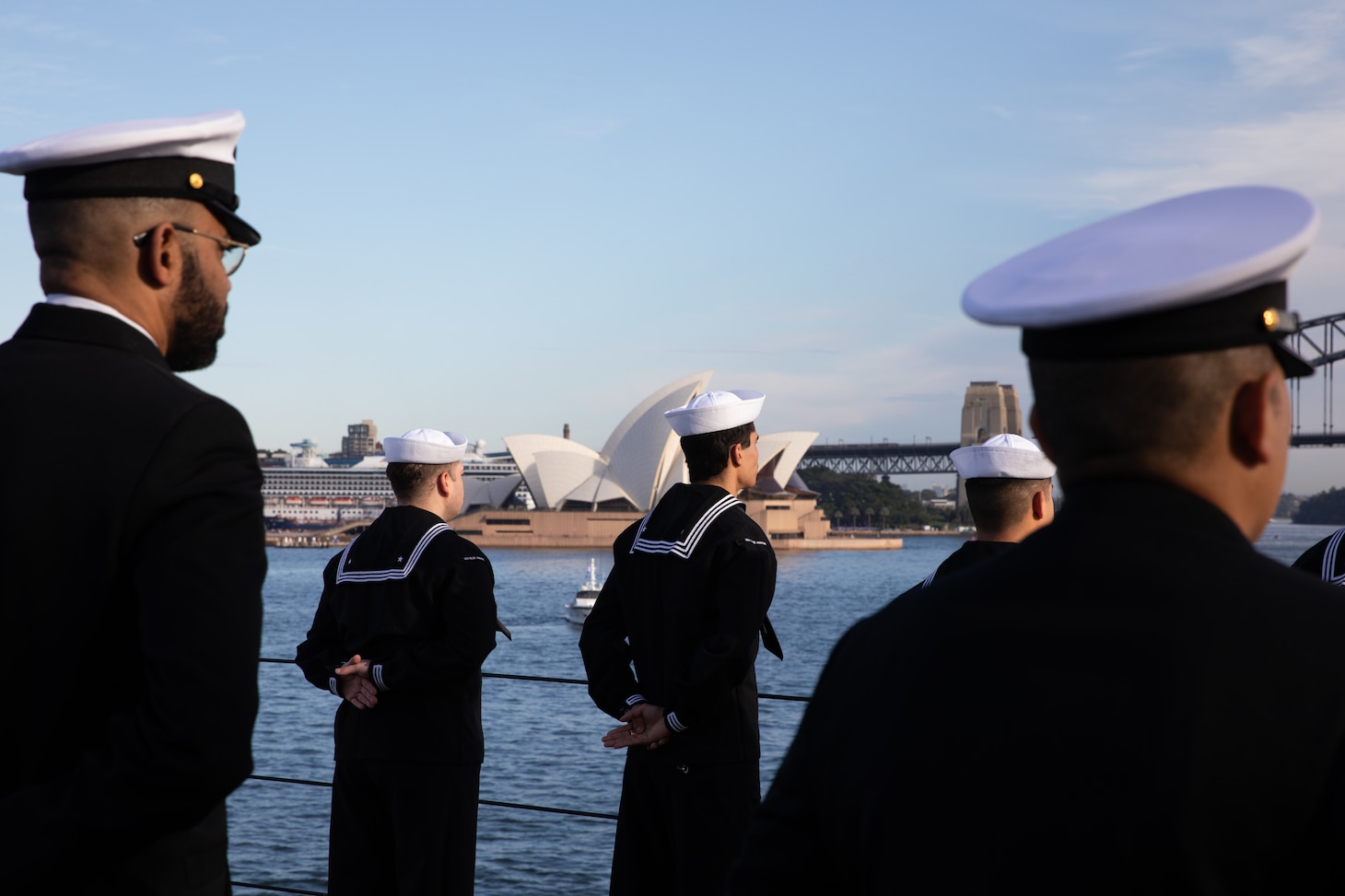 SYDNEY (May 26, 2025) - Sailors assigned to the U.S. 7th Fleet flagship USS Blue Ridge (LCC 19) and 7th Fleet Staff man the rails while pulling into Sydney, Australia for a scheduled port visit, May 26, 2025.  7th Fleet is the U.S. Navy's largest forward-deployed numbered fleet, and routinely interacts and operates with allies and partners in preserving a free and open Indo-Pacific region. (U.S. Navy photo by Lt.j.g. Sarah Merrill)