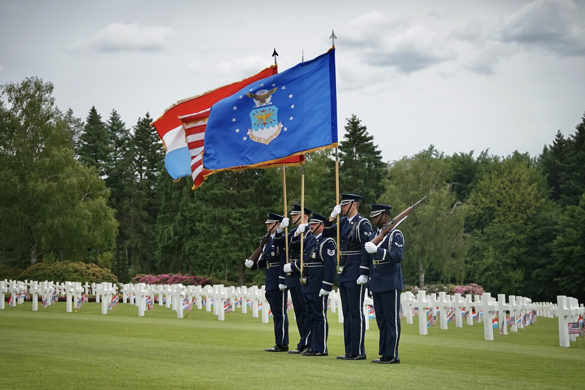U.S. Air Force Honor Guard members assigned to Spangdahlem Air Base present the colors during the Memorial Day ceremony at Luxembourg American Cemetery, May 24, 2025. The annual ceremony honors the legacy and sacrifice of U.S. service members who gave their lives during World War II, including more than 5,000 Americans buried at the site. (U.S. Air Force photo by 1st Lt Gabriele Gocso)