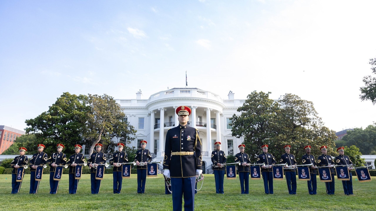 Bandsmen stand in formation in front of the White House.