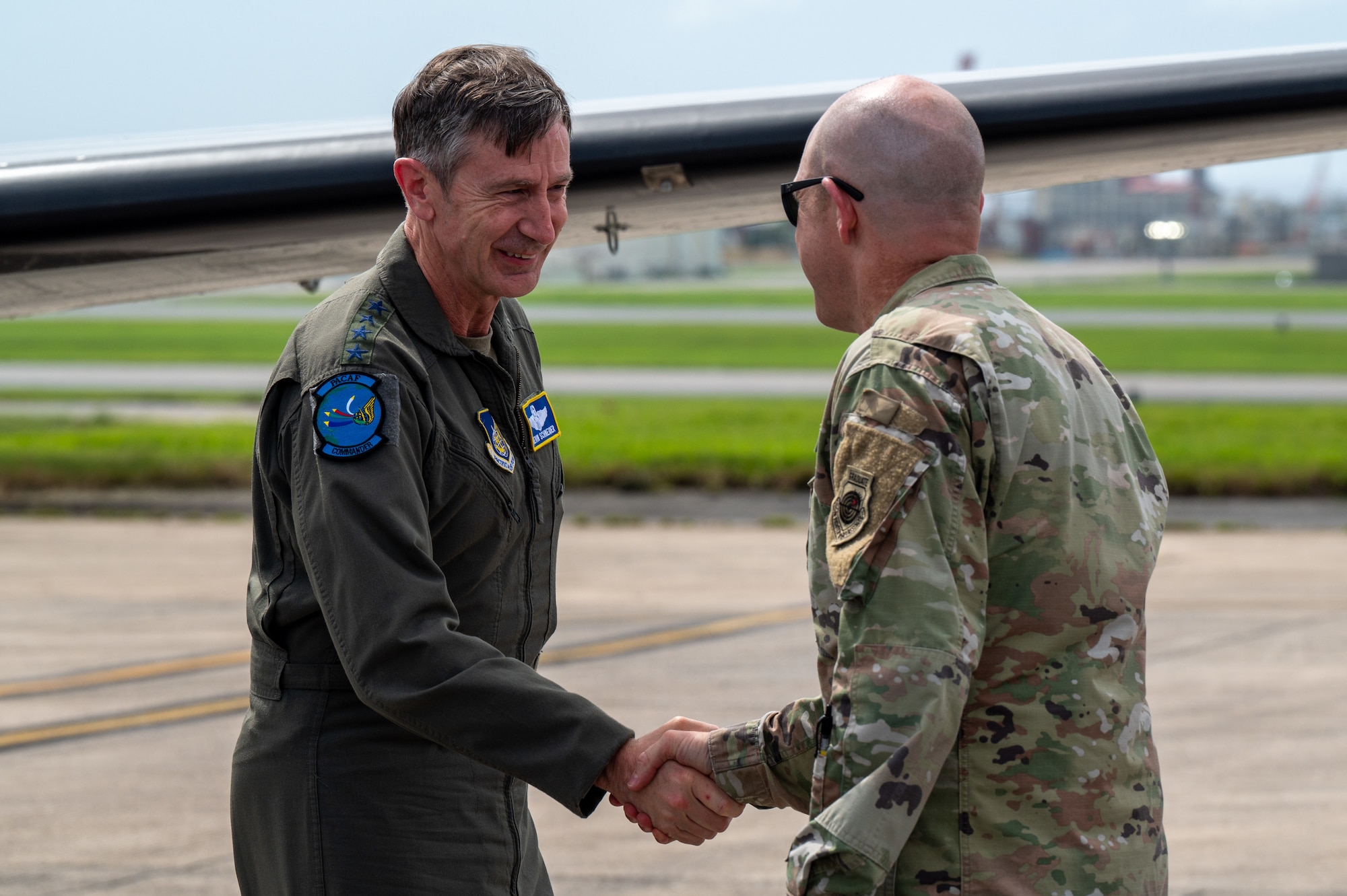 The 18th Wing commander greets the PACAF commander upon arrival to the installstion for an immersion tour.