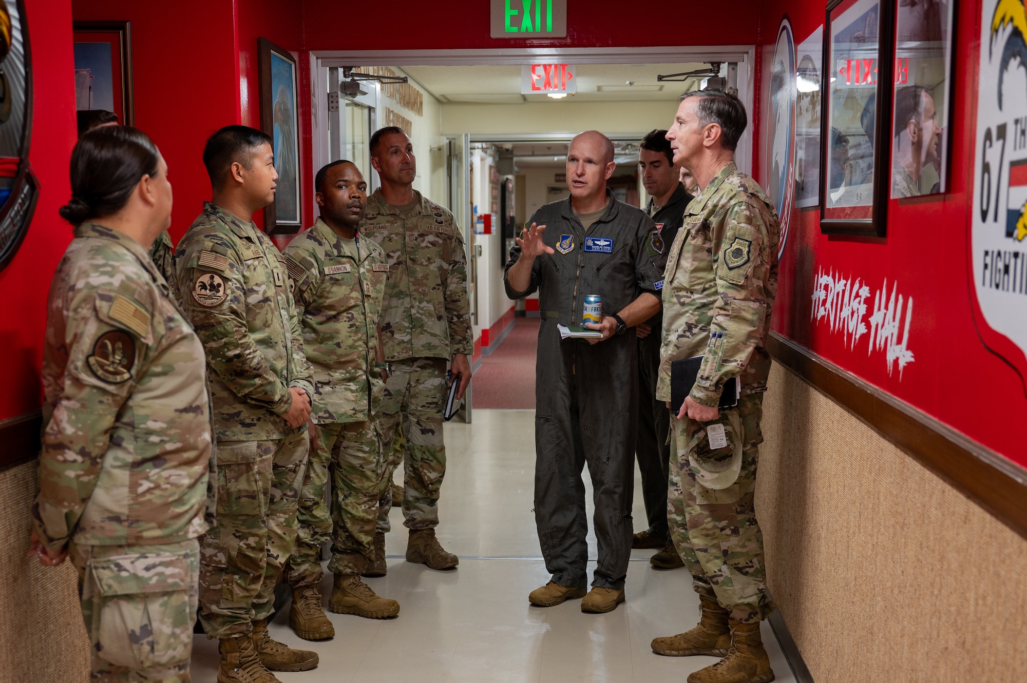 Airmen give the PACAF commander a tour of the 67th FGS heritage hall.
