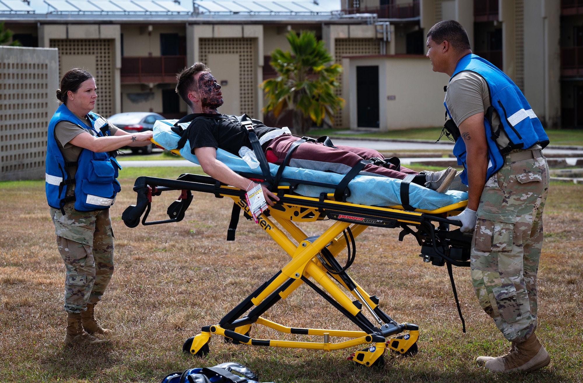 Tech Sgt. Kendra Morales, left, and Senior Airman Silas Carter, field response team members, transport a simulated casualty during a Mass Casualty Exercise on Andersen Air Force Base, Guam, May 14, 2025. The exercise simulated a hostile attack with multiple casualties with varying degrees of severity. The field response team was evaluated on their triage process and how quickly and efficiently they can make decisions that could save lives. (U.S. Air Force photo by Staff Sgt. Pedro Tenorio)