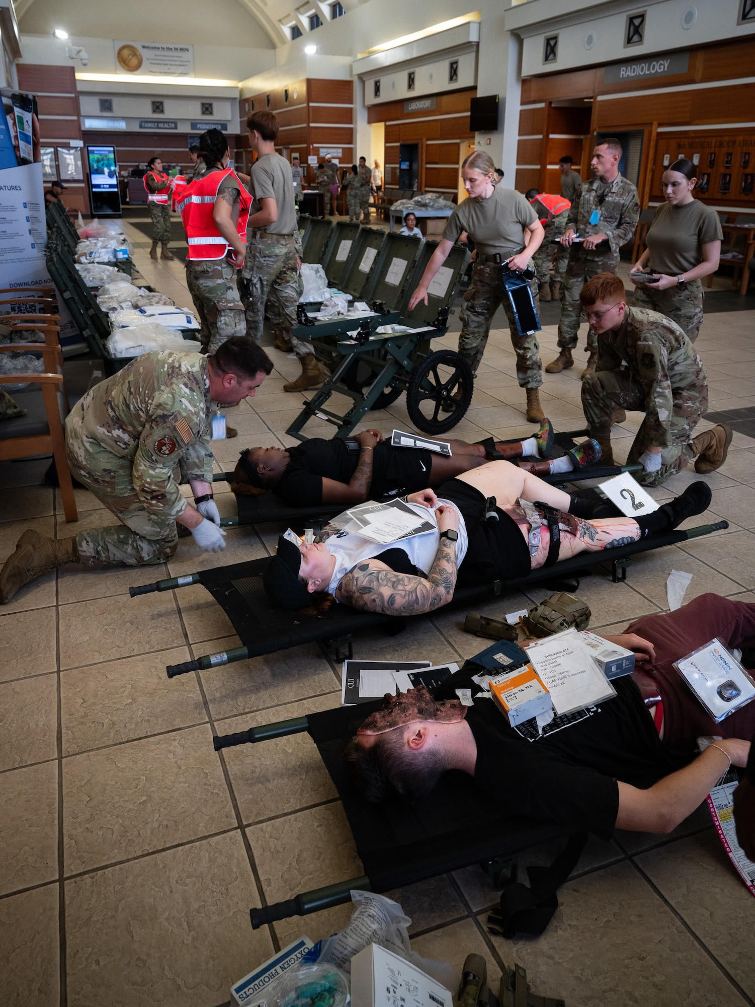 36th Medical Group Airmen transport simulated casualties into the final staging area during a Mass Casualty Exercise at Andersen Air Force Base, Guam, May 14, 2025. All MDG Airmen are trained for worst-case scenarios like a hostile attack. This means Airmen with primary duties like dentists, lab technicians, pharmacy techs, etc. also have their crisis response duties either serving as field response team members, decontamination team members, manpower and more. (U.S. Air Force photo by Staff Sgt. Pedro Tenorio)