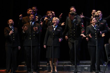 Uniformed bandsmen sing.