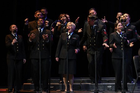 Uniformed bandsmen sing.
