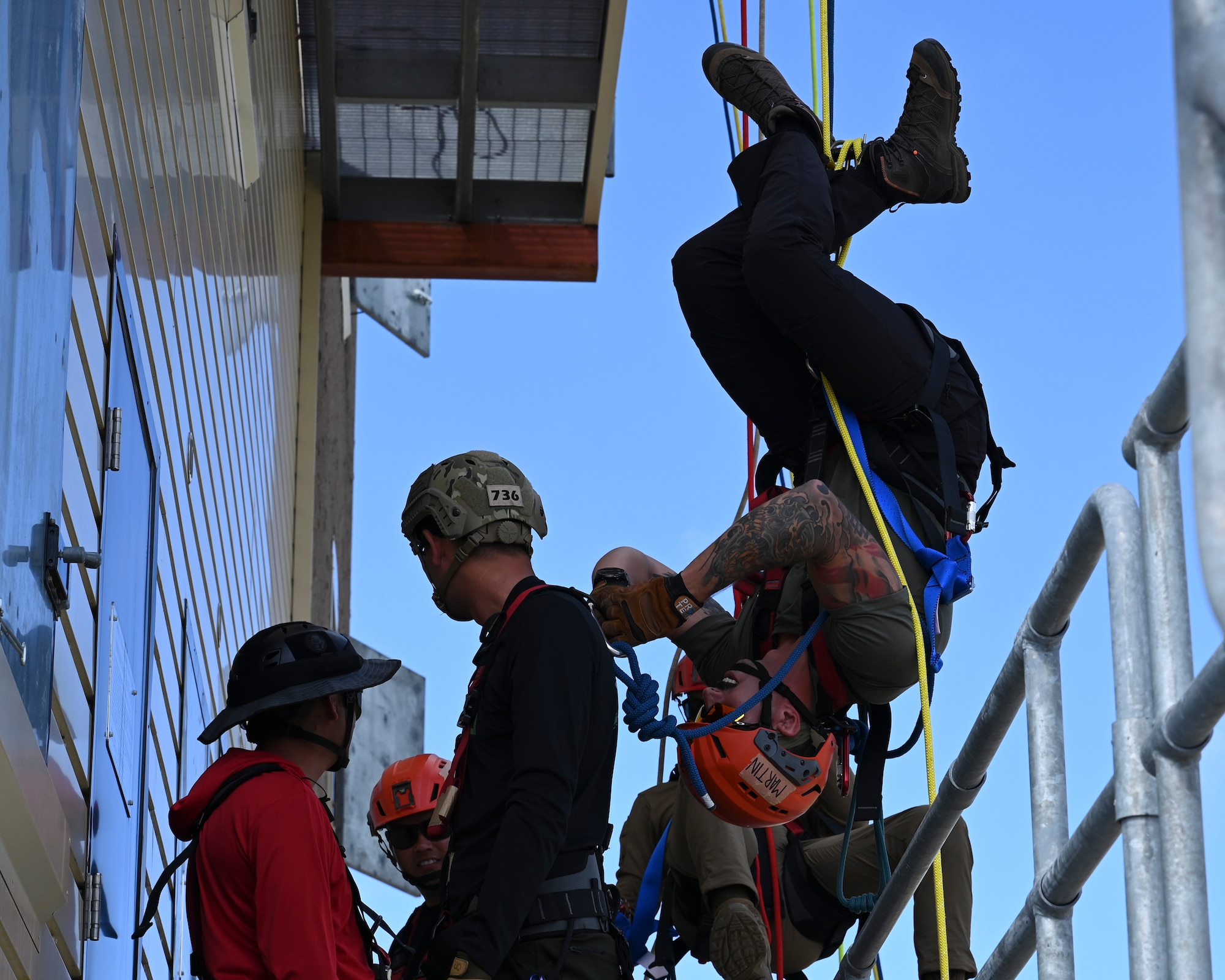 The Rapid Engineer Deployable Heavy Operational Repair Squadron Engineer Squadron, teaches students the importance of hooking the carabiner onto the victim at Andersen Air Force Base, Guam, May 7, 2025. This pick off rescue is performed in high angle environments, such as a cliff or a steep rock face.(U.S. Air Force photo by Airman 1st Class Joseph Maye)