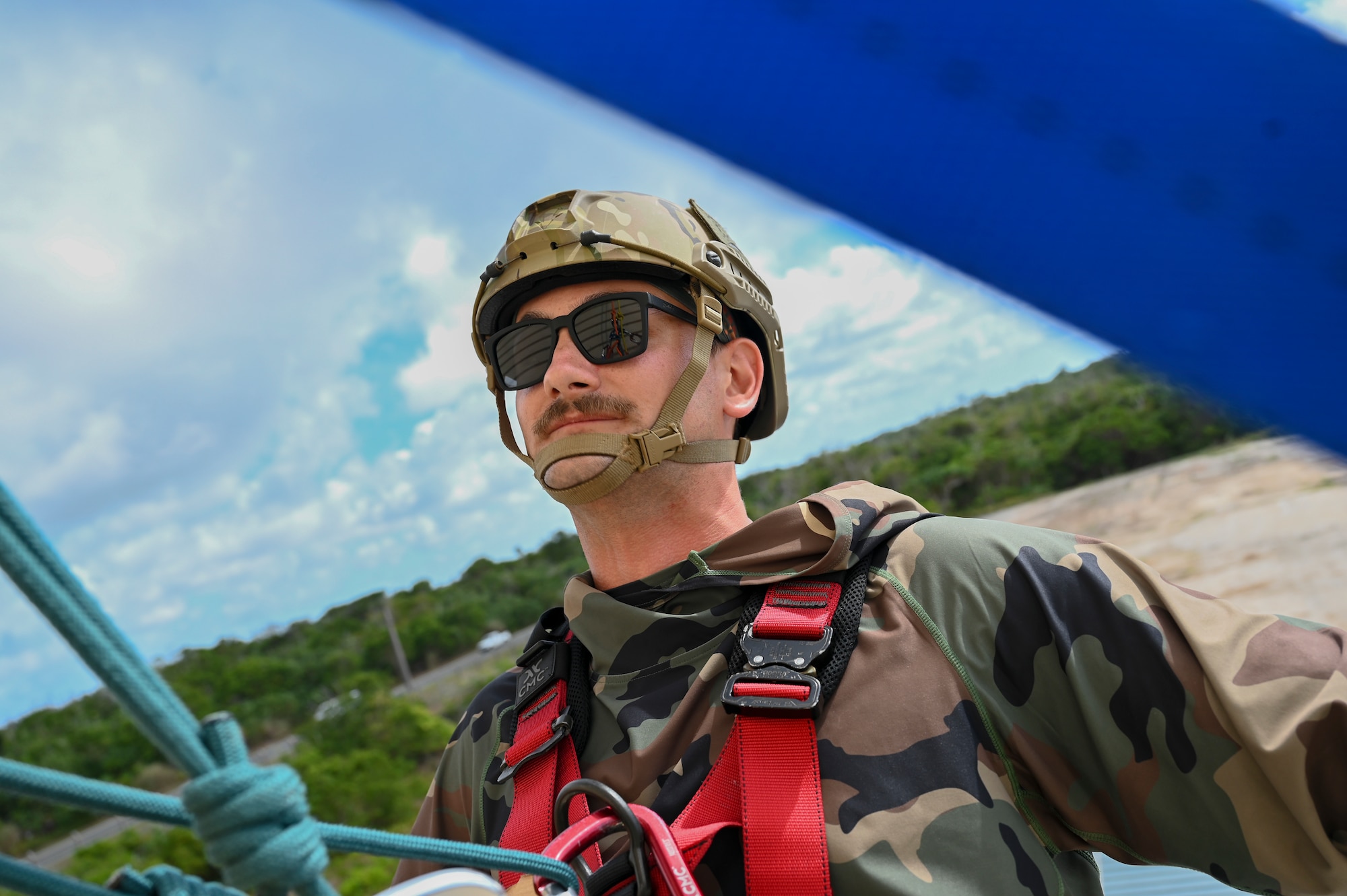 The Rapid Engineer Deployable Heavy Operational Repair Squadron Engineer Squadron, teaches students the importance of hooking the carabiner onto the victim at Andersen Air Force Base, Guam, May 7, 2025. This pick off rescue is performed in high angle environments, such as a cliff or a steep rock face.(U.S. Air Force photo by Airman 1st Class Joseph Maye)