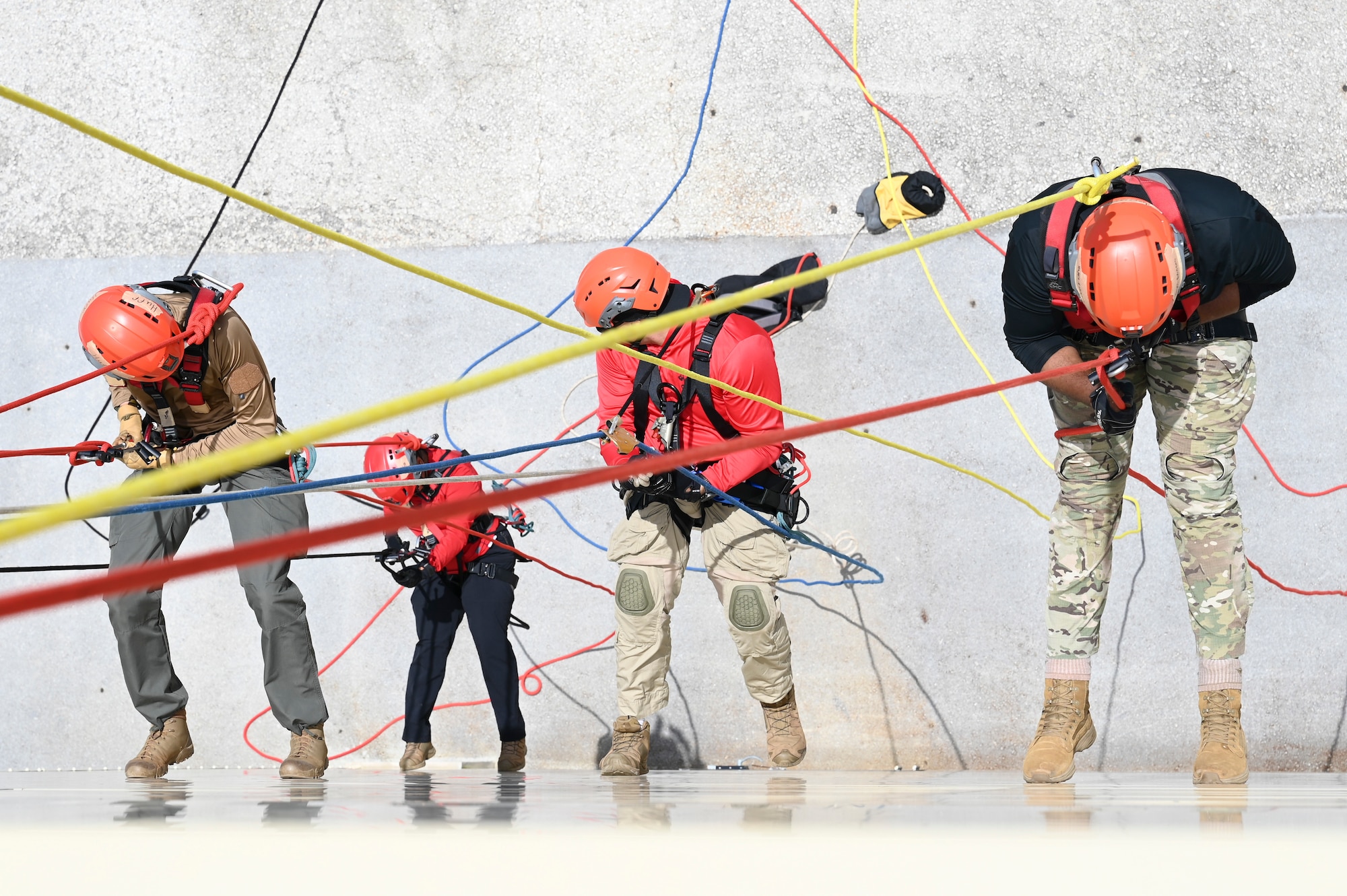 The Rapid Engineer Deployable Heavy Operational Repair Squadron Engineer Squadron, teaches students the importance of hooking the carabiner onto the victim at Andersen Air Force Base, Guam, May 7, 2025. This pick off rescue is performed in high angle environments, such as a cliff or a steep rock face.(U.S. Air Force photo by Airman 1st Class Joseph Maye)