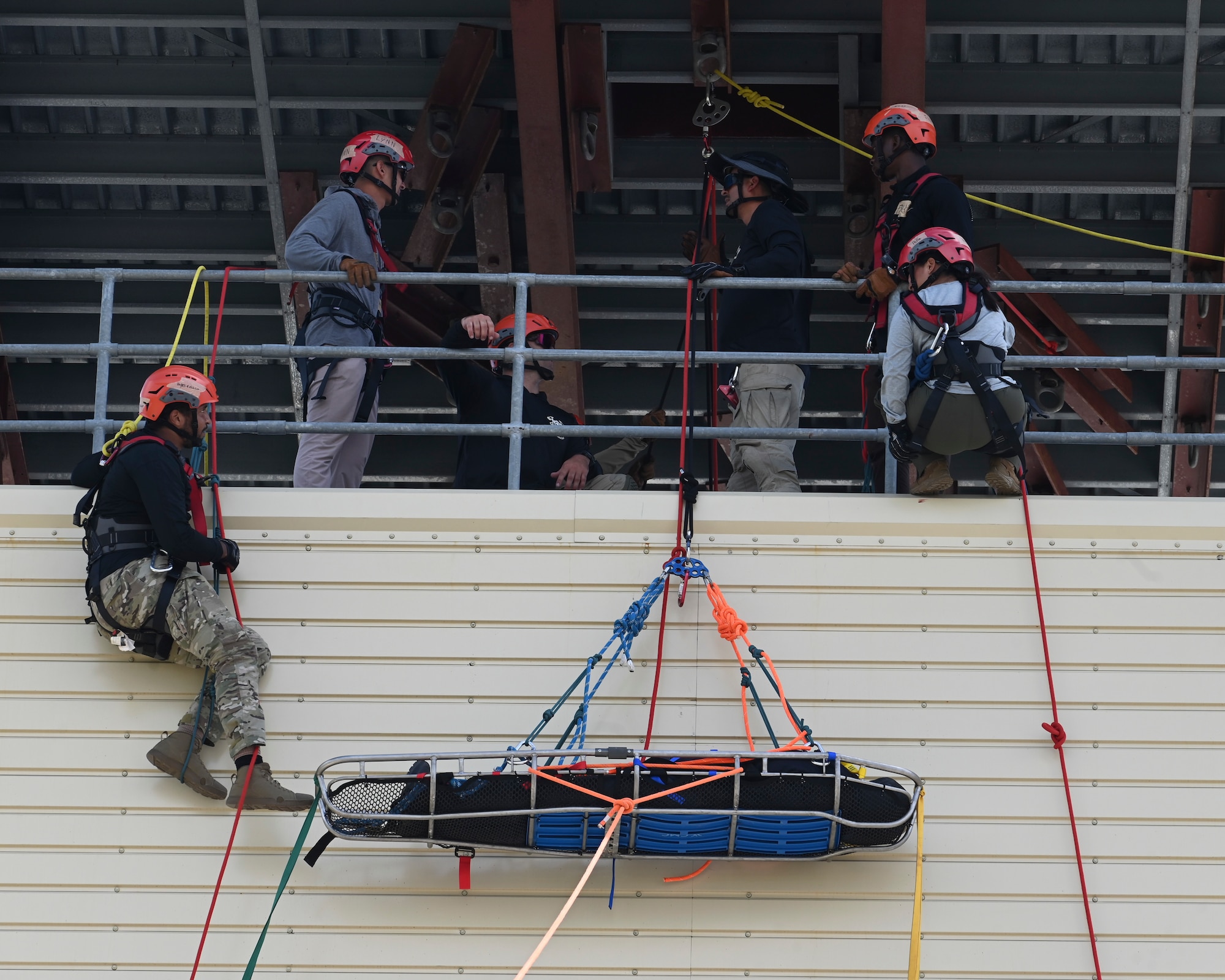 The Rapid Engineer Deployable Heavy Operational Repair Squadron Engineer Squadron, teaches students the importance of hooking the carabiner onto the victim at Andersen Air Force Base, Guam, May 7, 2025. This pick off rescue is performed in high angle environments, such as a cliff or a steep rock face.(U.S. Air Force photo by Airman 1st Class Joseph Maye)