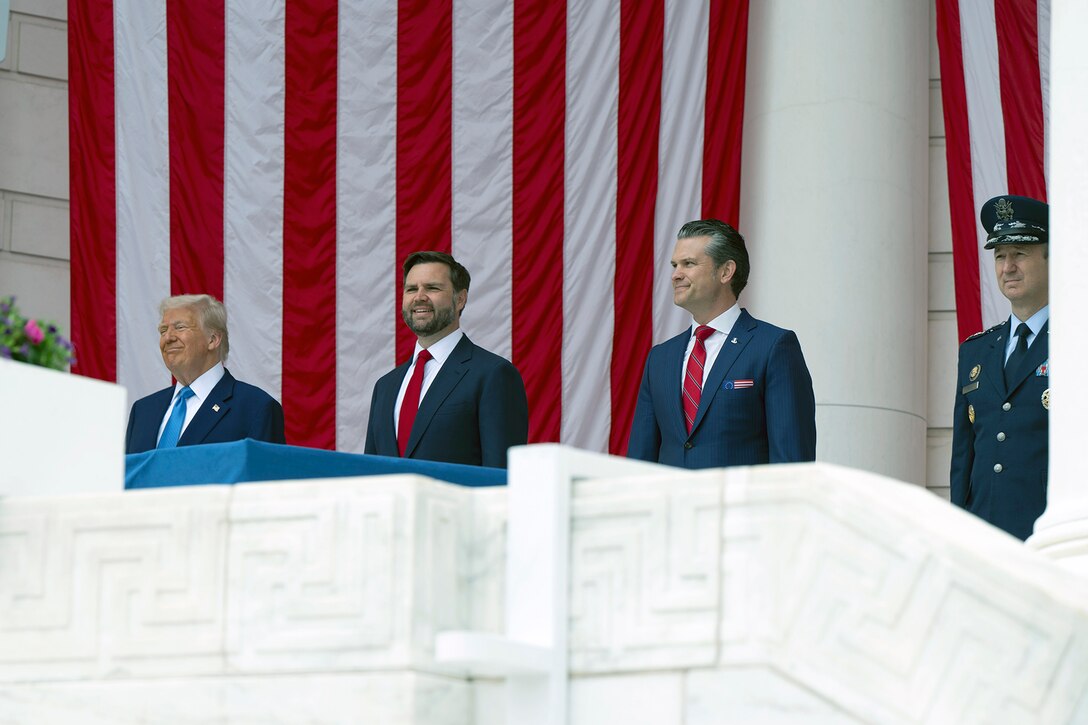 Nation's leaders smile while standing in front of an American flag.