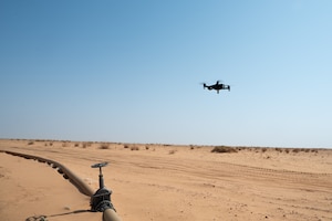 A drone flies over a fuel line in the desert