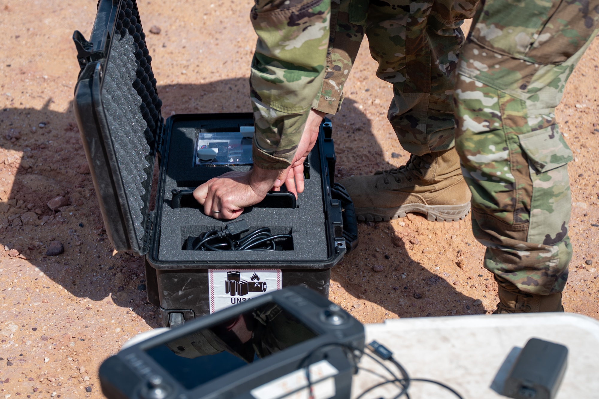 Airmen secures a drone in a Pelican Case