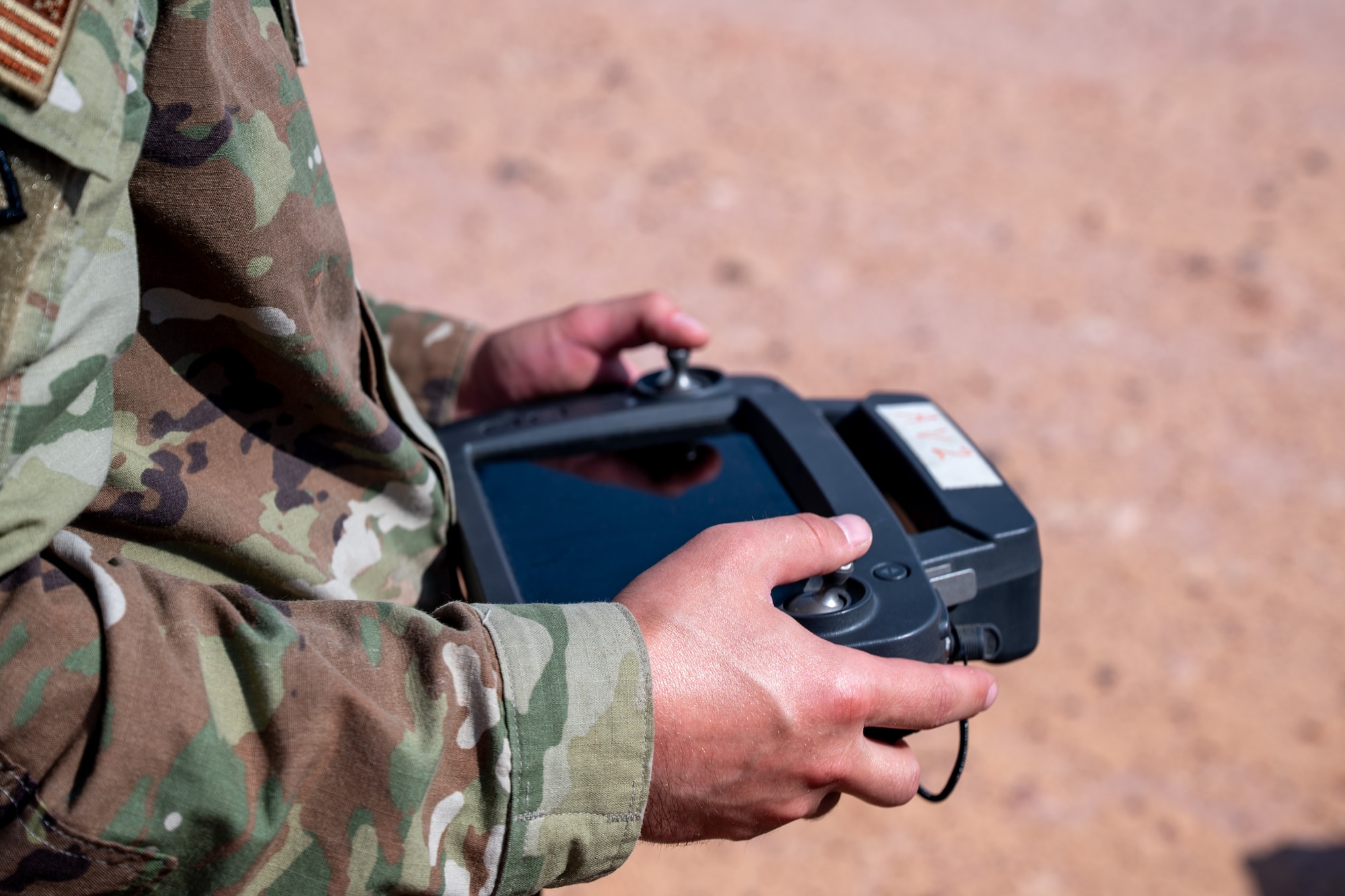 Airmen holds a drone controler