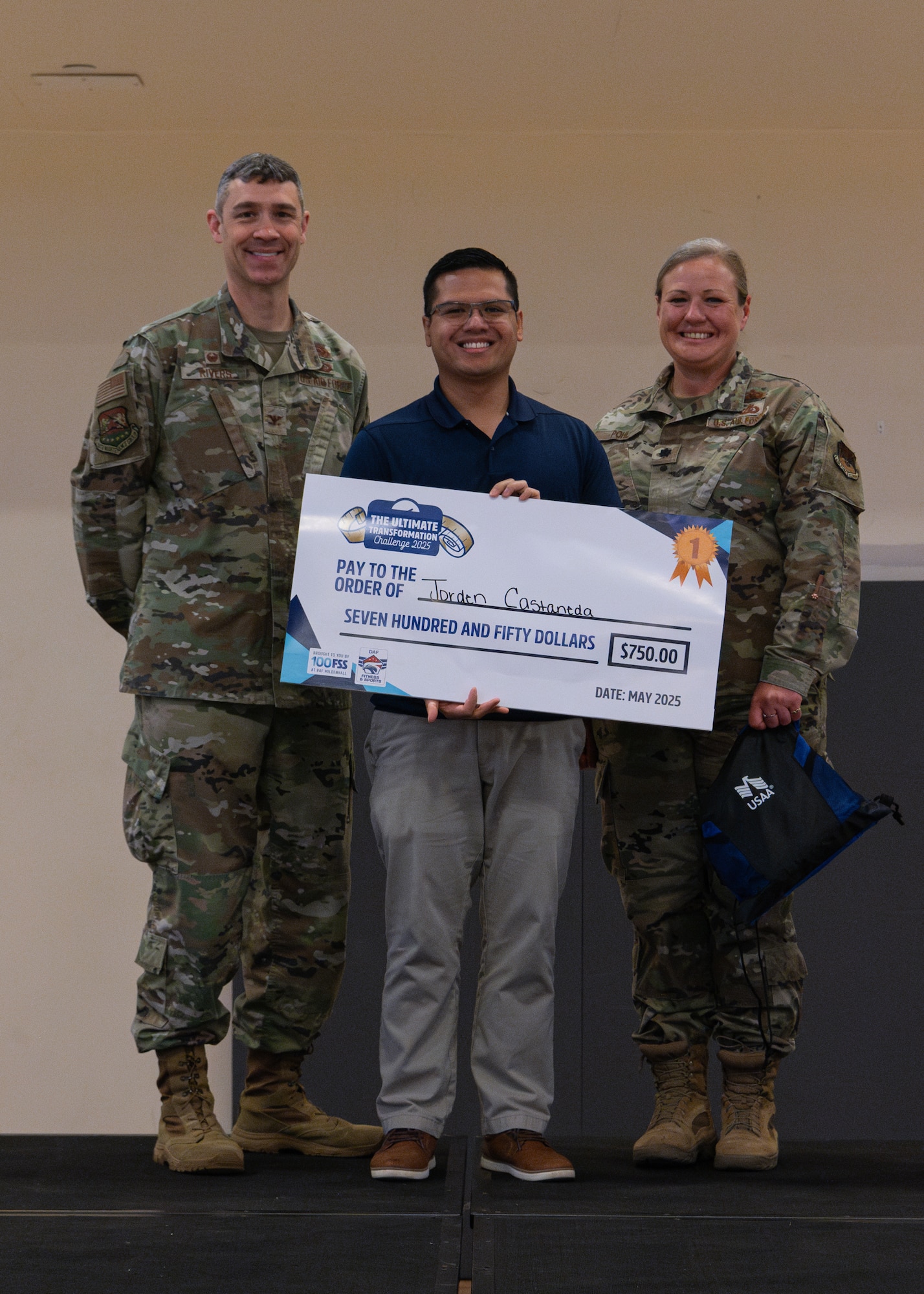 U.S. Air Force Col. Aaron Rivers, left, 100th Maintenance Group commander, Maj. Jorden Castaneda, Air Force Installation and Mission Support Center deputy branch chief, center, and Lt. Col. Kathleen Pohl, 48th Fighter Wing Human Performance Optimization lead, pose for a photo during the Tri-Base Ultimate Transformation Challenge 2025 closing ceremony at RAF Mildenhall, England, May 22, 2025. Running from Jan. 6 to May 16, the objective of the UTC 2025 was to equip members with the knowledge, resources, and intrinsic motivation necessary to achieve sustained personal health and fitness goals that extend beyond the duration of the challenge. (U.S. Air Force photo by Airman 1st Class Aidan Martínez)