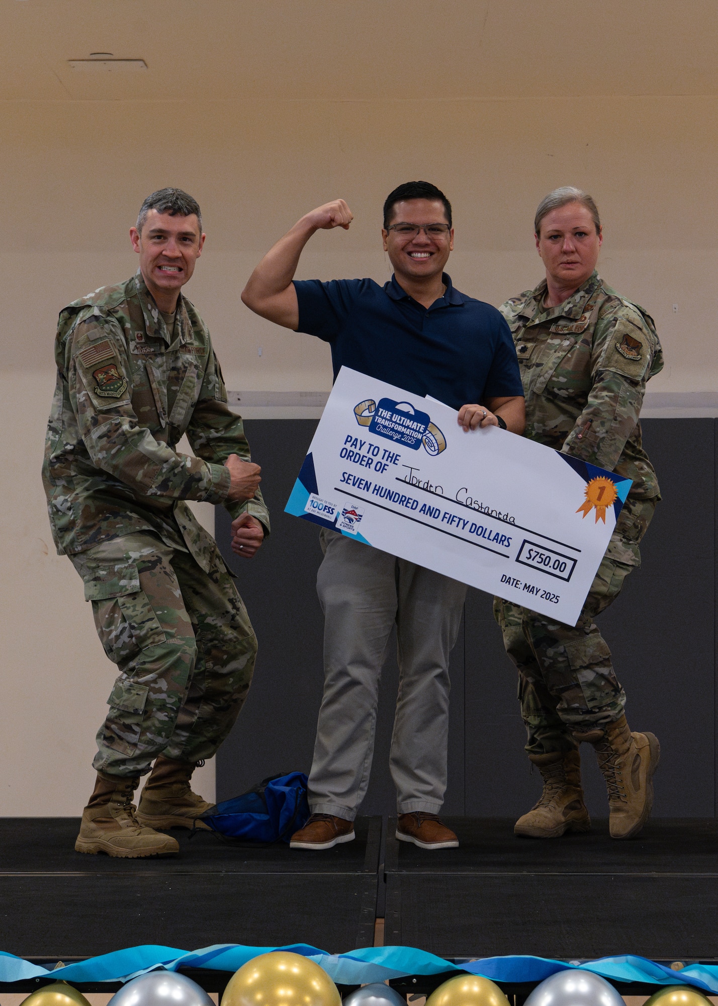 U.S. Air Force Col. Aaron Rivers, left, 100th Maintenance Group commander, Maj. Jorden Castaneda, Air Force Installation and Mission Support Center deputy branch chief, center, and Lt. Col. Kathleen Pohl, 48th Fighter Wing Human Performance Optimization lead, pose for a photo during the Tri-Base Ultimate Transformation Challenge 2025 closing ceremony at RAF Mildenhall, England, May 22, 2025. Running from Jan. 6 to May 16, the objective of the UTC 2025 was to equip members with the knowledge, resources, and intrinsic motivation necessary to achieve sustained personal health and fitness goals that extend beyond the duration of the challenge. (U.S. Air Force photo by Airman 1st Class Aidan Martínez)