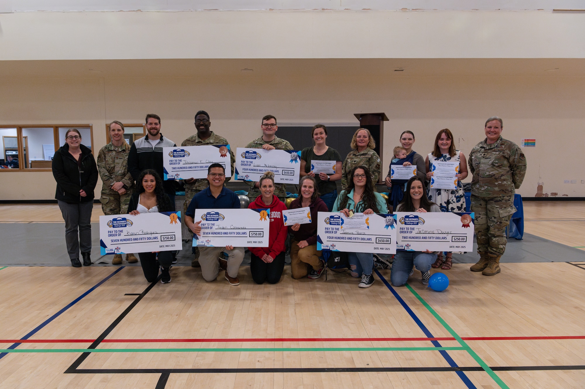 Members of the tri-base area community pose for a photo during the Tri-Base Ultimate Transformation Challenge 2025 closing ceremony at RAF Mildenhall, England, May 22, 2025. Running from Jan. 6 to May 16, the objective of the UTC 2025 was to equip members with the knowledge, resources, and intrinsic motivation necessary to achieve sustained personal health and fitness goals that extend beyond the duration of the challenge.
