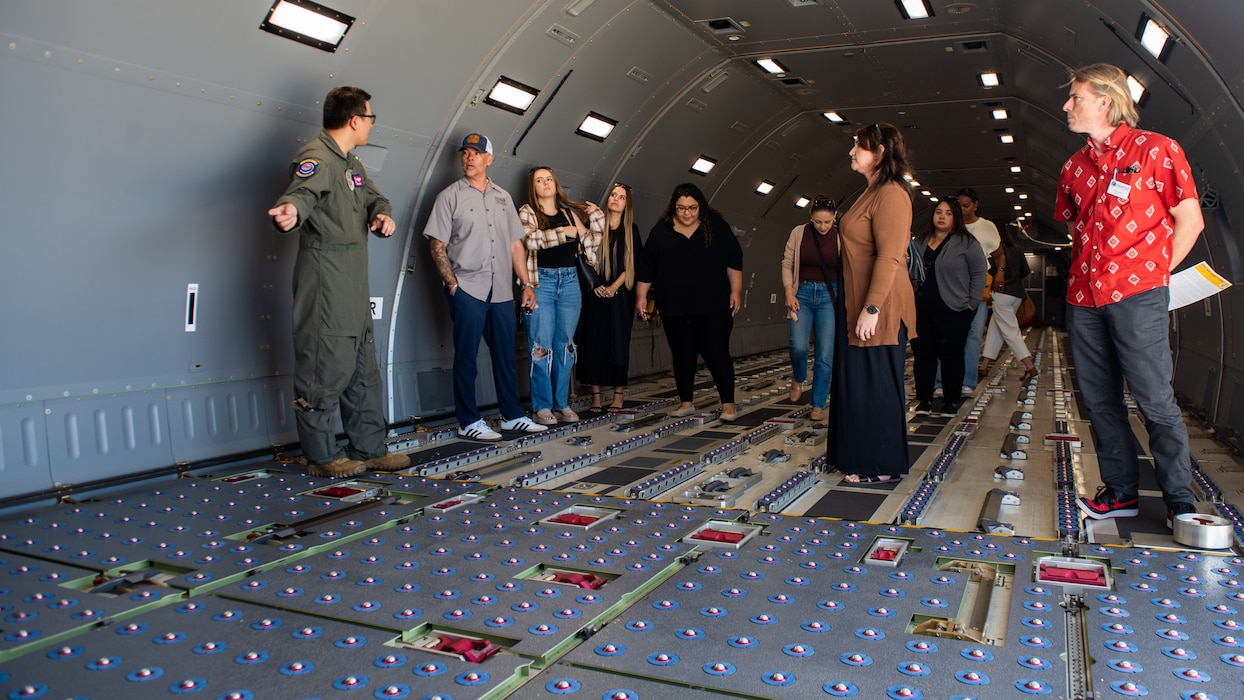 Local leadership tour the inside of an aircraft on the flight line