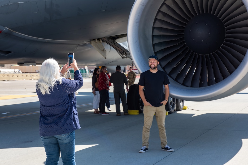 Local leadership take a photo in front of aircraft on the flight line