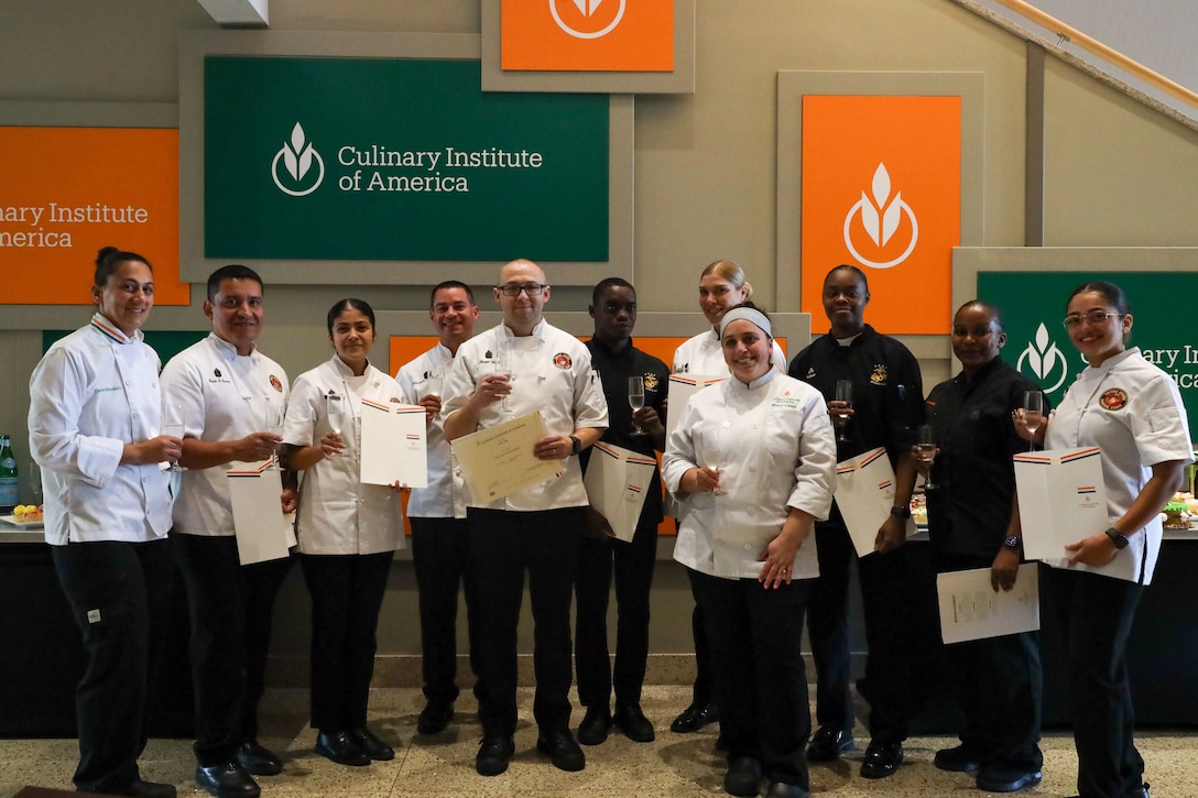 U.S. Marines with the Marine Corps Enlisted Aide Program pose with their instructor after completing a cake decorating course at the Culinary Institute of America in Hyde Park, New York, on Sept. 12, 2024. Marines with the Marine Corps Enlisted Aide Program took the course in preparation for the 249th Marine Corps Birthday Ball season. The training aimed to enhance their culinary presentation skills for official events. (U.S. Marine Corps photo by Lance Cpl. Christopher Prelle)