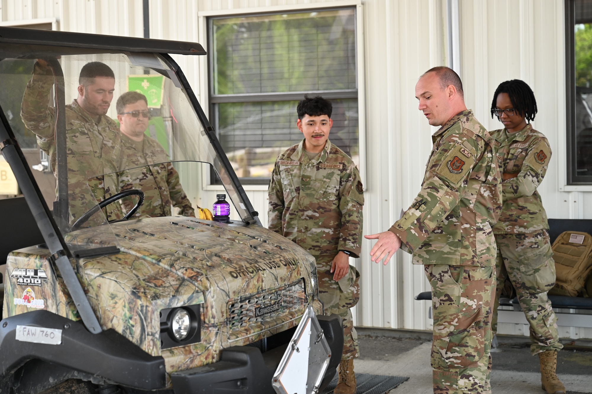 U.S. Air Force Tech. Sgt. Danny Newman, second from right, 87th Aerial Port Squadron joint inspection supervisor craftsman, conducts center of balance training while on annual tour at Joint Base Charleston, S.C., April 10, 2025. CB training includes weighing a vehicle at each axle, measuring the vehicle and performing the necessary math to find the center of balance of the vehicle. (U.S. Air Force photo by Tech. Sgt. Joel McCullough)