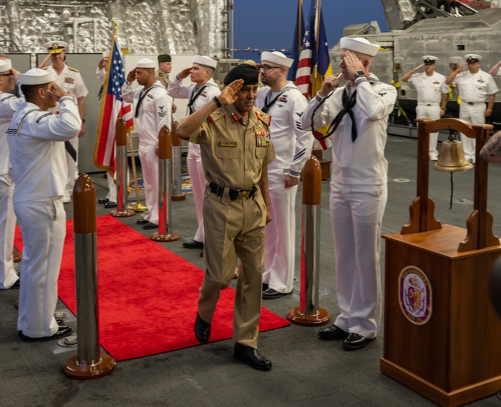Lt. Gen. Theyab bin Saqr Al Nuaimi, Chief of Staff of the Bahrain Defence Force, is piped aboard the littoral combat ship USS Canberra (LCS 30) during a visit to the ship at Naval Support Activity Bahrain, May 26. Canberra, an Independence variant of LCS, is deployed to the region to maintain regional maritime security in the Middle East region.