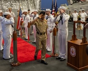 Lt. Gen. Theyab bin Saqr Al Nuaimi, Chief of Staff of the Bahrain Defence Force, is piped aboard the littoral combat ship USS Canberra (LCS 30) during a visit to the ship at Naval Support Activity Bahrain, May 26. Canberra, an Independence variant of LCS, is deployed to the region to maintain regional maritime security in the Middle East region.