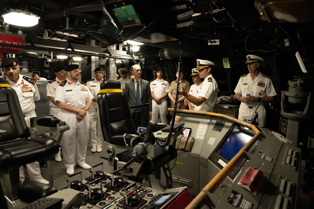 Cmdr. Bill Golden, center, commanding officer of the littoral combat ship USS Canberra’s (LCS 30) Blue Crew, gives a tour of the ship’s bridge in Manama, Bahrain, May 26. Canberra, an Independence variant of LCS, is deployed to the region to maintain regional maritime security in the Middle East region.