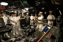 Cmdr. Bill Golden, center, commanding officer of the littoral combat ship USS Canberra’s (LCS 30) Blue Crew, gives a tour of the ship’s bridge in Manama, Bahrain, May 26. Canberra, an Independence variant of LCS, is deployed to the region to maintain regional maritime security in the Middle East region.