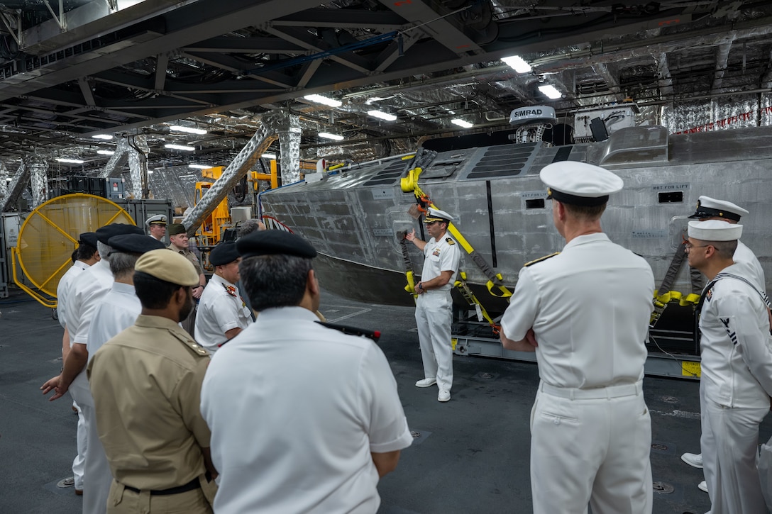 Cmdr. Bill Golden, commanding officer of USS Canberra’s (LCS 30) Blue Crew, discusses the mine countermeasures unmanned surface vehicle in the ship’s mission bay to Bahrain Defence Force officials in Manama, Bahrain. Canberra, an Independence variant of LCS, is deployed to the region to maintain regional maritime security in the Middle East region.