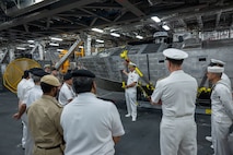 Cmdr. Bill Golden, commanding officer of USS Canberra’s (LCS 30) Blue Crew, discusses the mine countermeasures unmanned surface vehicle in the ship’s mission bay to Bahrain Defence Force officials in Manama, Bahrain. Canberra, an Independence variant of LCS, is deployed to the region to maintain regional maritime security in the Middle East region.