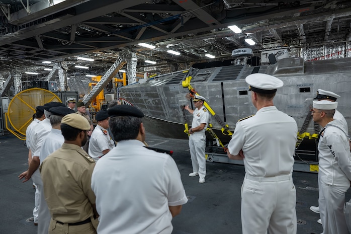 Cmdr. Bill Golden, commanding officer of USS Canberra’s (LCS 30) Blue Crew, discusses the mine countermeasures unmanned surface vehicle in the ship’s mission bay to Bahrain Defence Force officials in Manama, Bahrain. Canberra, an Independence variant of LCS, is deployed to the region to maintain regional maritime security in the Middle East region.