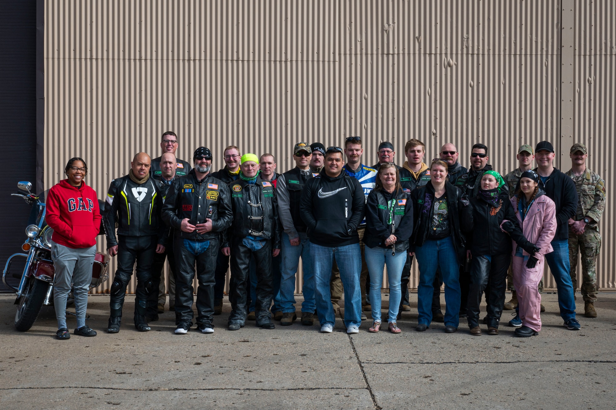A group of motorcyclists pose for a photo at Grand Forks Air Force Base, N.D., May 2, 2025. In addition to 17 motorcyclists, two chase vehicles were sent with safety and medical support teams to ensure riders had support in the case of an emergency. (U.S. Air Force photo by Airman 1st Class Emma Funderburk)