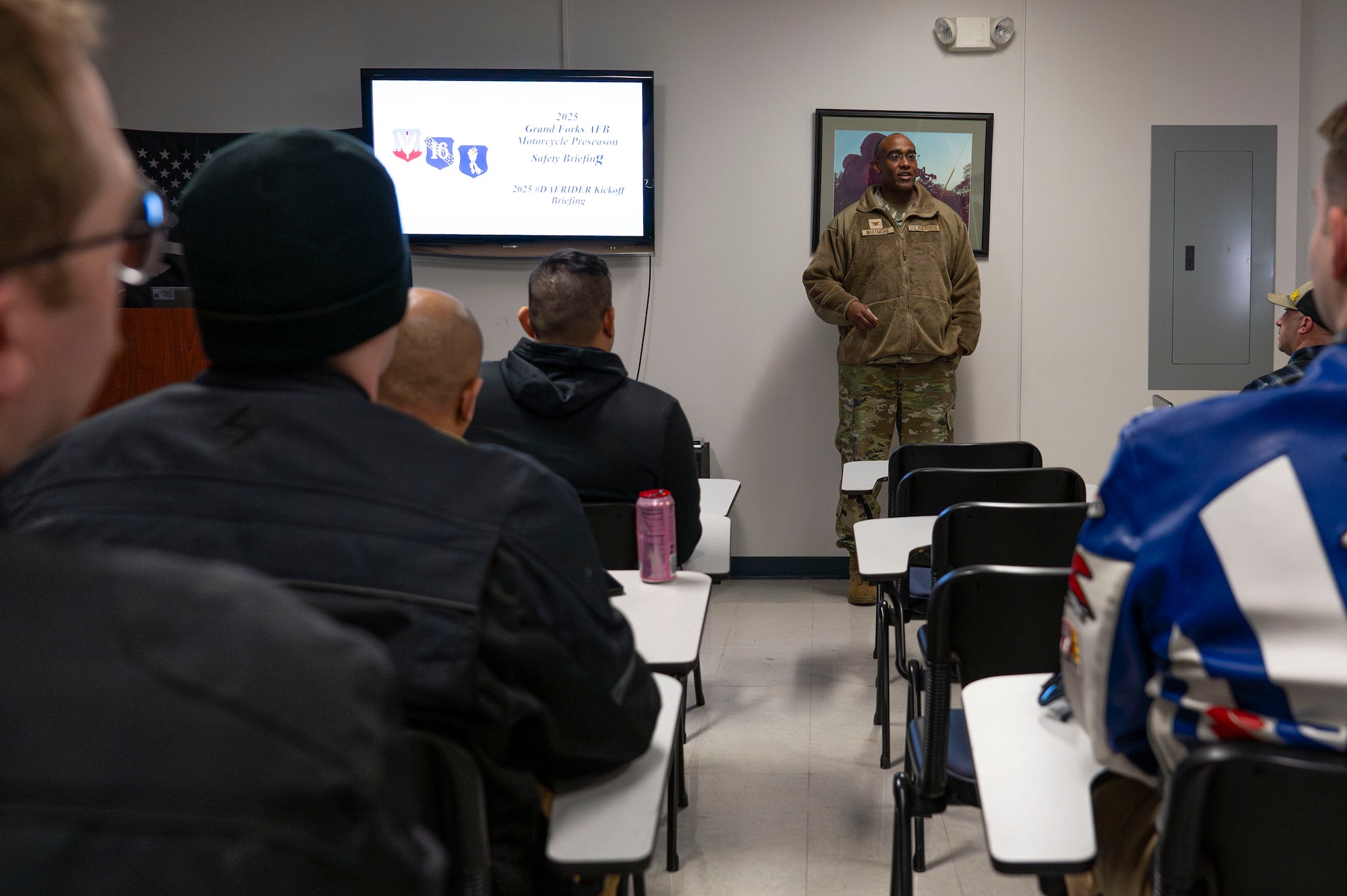 Col. Bishane Whitmore, 319th Reconnaissance Wing deputy commander, gives opening comments before a motorcycle safety brief at Grand Forks Air Force Base, N.D., May 2, 2025. The class was an opportunity for new motorcyclists to meet AFI-directed requirements for motorcycle operations and offered a safety brief or for senior cyclists to stay up-to-date with safety knowledge. (U.S. Air Force photo by Airman 1st Class Emma Funderburk)