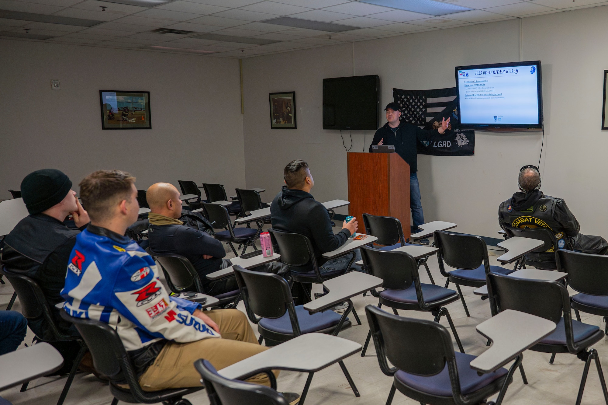 Staff Sgt. Kendall Blaire, 319th Reconnaissance Wing occupational safety technician; Tech. Sgt. Steven Phelps, 319th Logistics Readiness Squadron air transportation function non-commissioned officer in charge and Tyler Okerlund, 319th Contracting Squadron contract specialist, brief a class of motorcyclists on road safety at Grand Forks Air Force Base, N.D., May 2, 2025. The class was considered a refresher course for airmen who have already completed their Basic Riders Course One requirement. (U.S. Air Force photo by Airman 1st Class Emma Funderburk)