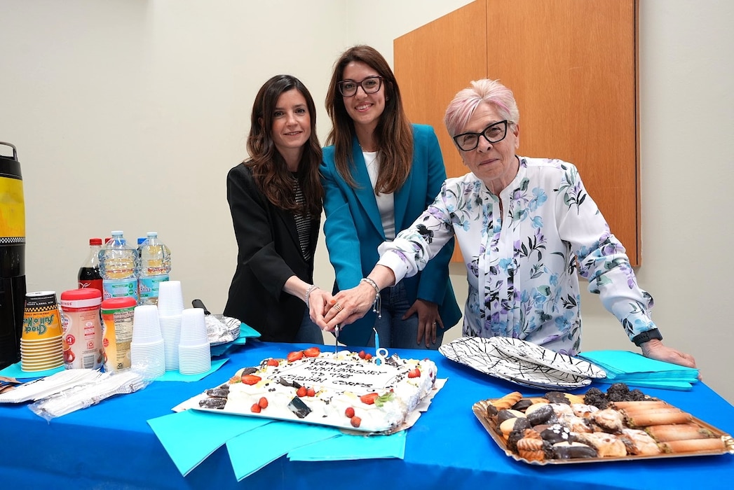 250522-N-DY427-5490 SIGONELLA, Italy. (May 21, 2025) Nellie Barone, Ilenya Llardo, and Chiara Caputo, the most junior and senior Local National Civilian personnel present at the event, assigned to U.S. Navy Medicine and Readiness Training Command (NMRTC) Sigonella, cut the cake during the Civilian Resource Fair. The command-wide event celebrated the unwavering dedication of more than 120 civilian team members, including Local Nationals (LNs) and General Schedule (GS) employees across three locations. Hosted by the Civilian Corps Board (CCB), the fair provided a vibrant space for connection, professional growth, and appreciation. Now in its eighth year, the Civilian Corps is a vital component of Navy Medicine’s enterprise-wide mission. Across the globe, civilian professionals bring continuity, expertise, and innovation to military treatment facilities, ensuring warfighters and their families receive consistent, high-quality care in every theater of operation. (U.S. Navy photo by Lieutenant Commander Brandi Gibson)