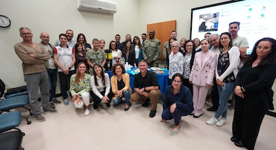 250522-N-DY427-6646 SIGONELLA, Italy. (May 21, 2025)  Captain TaRail A. Vernon, Commanding Officer of U.S. Navy Medicine and Readiness Training Command (NMRTC) Sigonella, recognizes the Civilian workforce during the Civilian Corps Resource Fair. The command-wide event celebrated the unwavering dedication of more than 120 civilian team members, including Local Nationals (LNs) and General Schedule (GS) employees across three locations. Hosted by the Civilian Corps Board (CCB), the fair provided a vibrant space for connection, professional growth, and appreciation. Now in its eighth year, the Civilian Corps is a vital component of Navy Medicine’s enterprise-wide mission. Across the globe, civilian professionals bring continuity, expertise, and innovation to military treatment facilities, ensuring warfighters and their families receive consistent, high-quality care in every theater of operation. (U.S. Navy photo by Lieutenant Commander Brandi Gibson)
