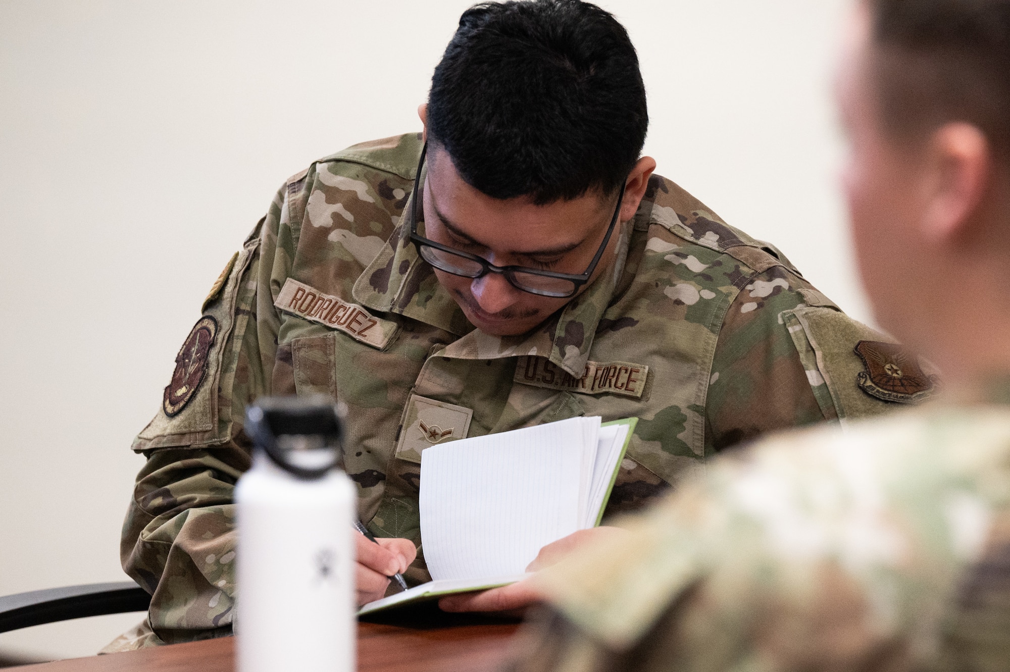 An Airman takes notes during a training session.