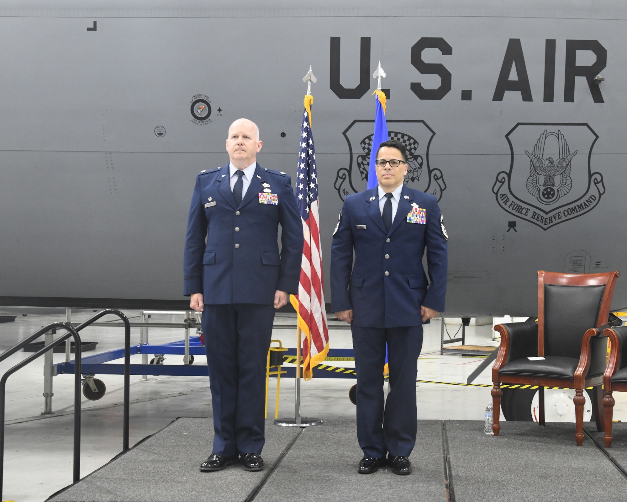 Senior Master Sgt. Erick Perez, 69th Aerial Port Squadron, promotes to the rank of Chief Master Sergeant during his promotion ceremony at the 459th Air Refueling Wing held on May 4, 2025. His family did the honors of pinning the rank on him, and Lt. Col. Edward Buck (left), 69th APS Commander, was the presiding official. (U.S. Air Force photo by Lt. Col. Timothy Smith)