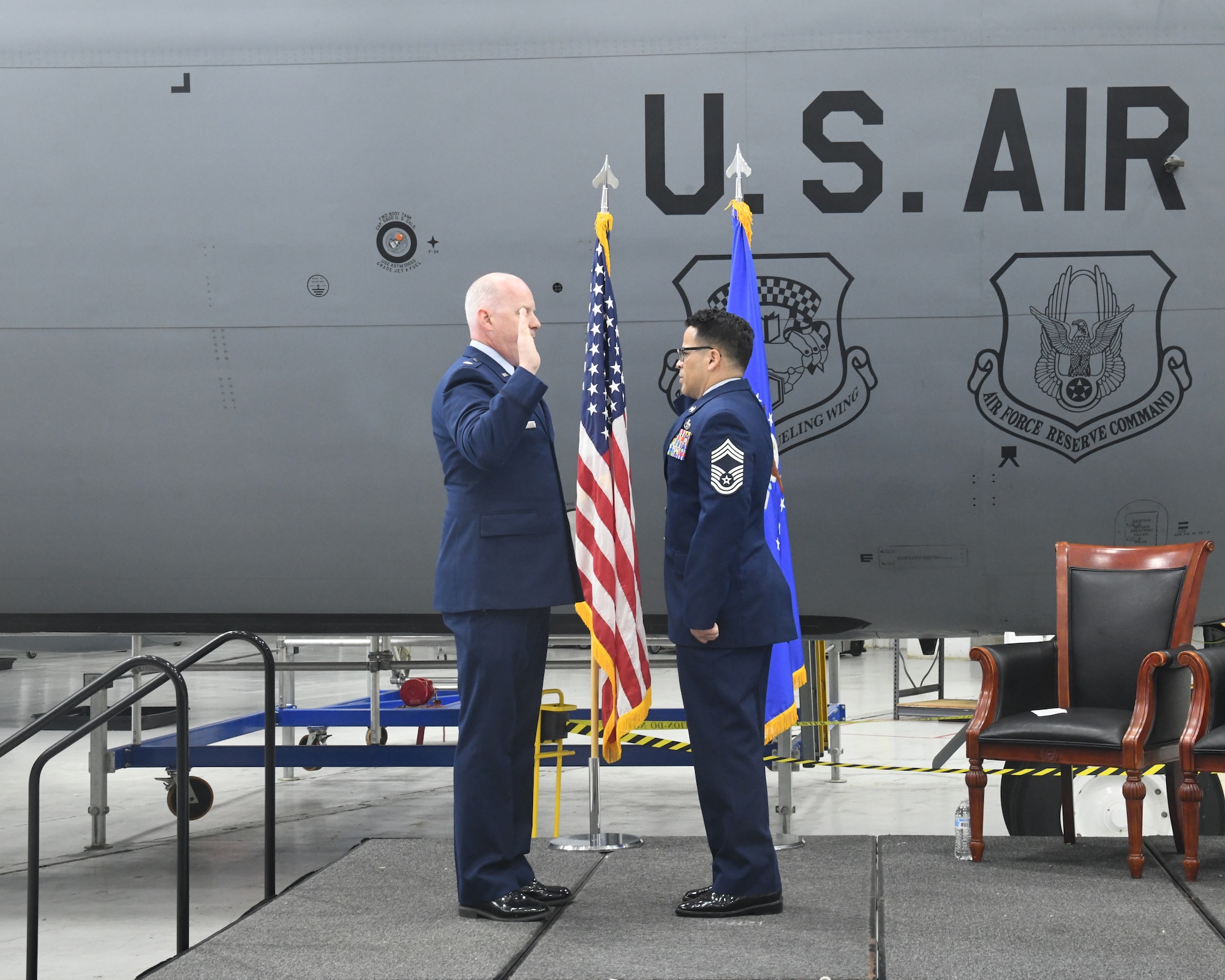 Senior Master Sgt. Erick Perez, 69th Aerial Port Squadron, promotes to the rank of Chief Master Sergeant during his promotion ceremony at the 459th Air Refueling Wing held on May 4, 2025. His family did the honors of pinning the rank on him, and Lt. Col. Edward Buck (left), 69th APS Commander, was the presiding official. (U.S. Air Force photo by Lt. Col. Timothy Smith)
