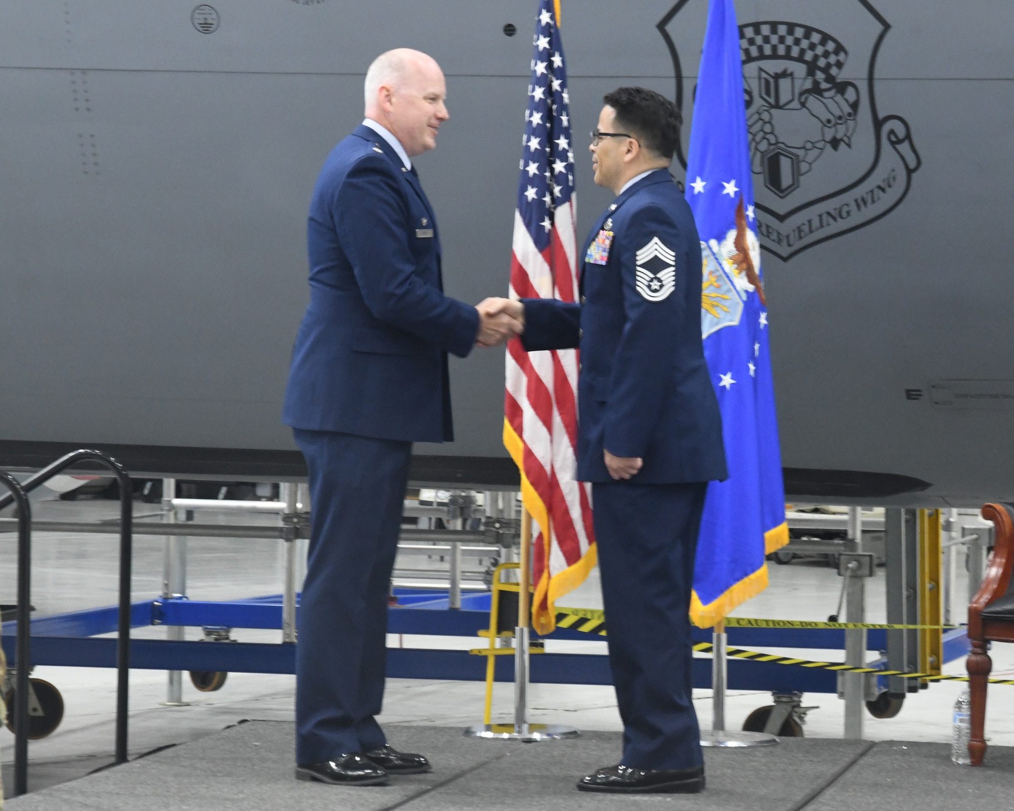 Senior Master Sgt. Erick Perez, 69th Aerial Port Squadron, promotes to the rank of Chief Master Sergeant during his promotion ceremony at the 459th Air Refueling Wing held on May 4, 2025. His family did the honors of pinning the rank on him, and Lt. Col. Edward Buck (left), 69th APS Commander, was the presiding official. (U.S. Air Force photo by Lt. Col. Timothy Smith)
